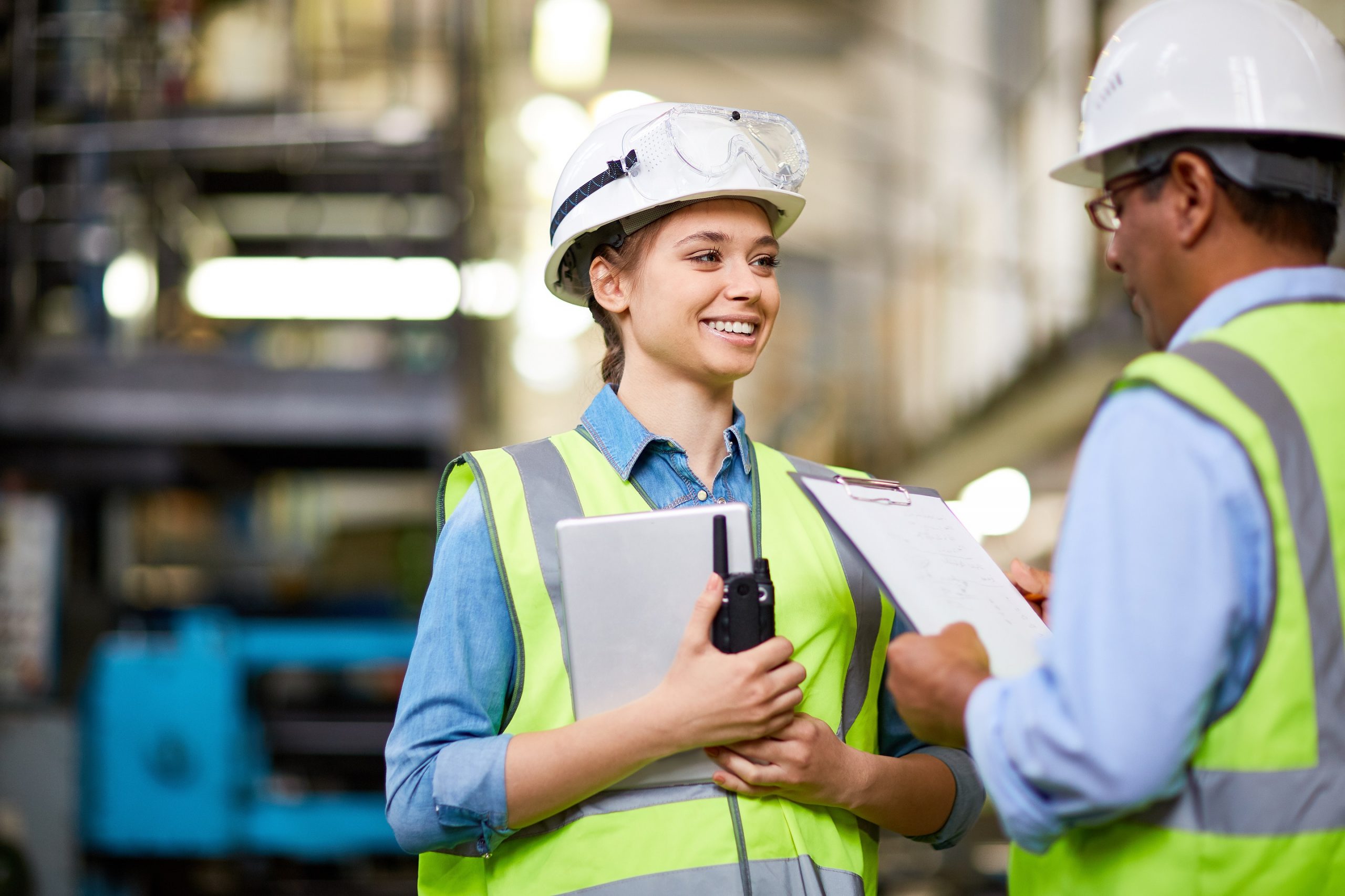 female engineer talking to a male colleague in a factory