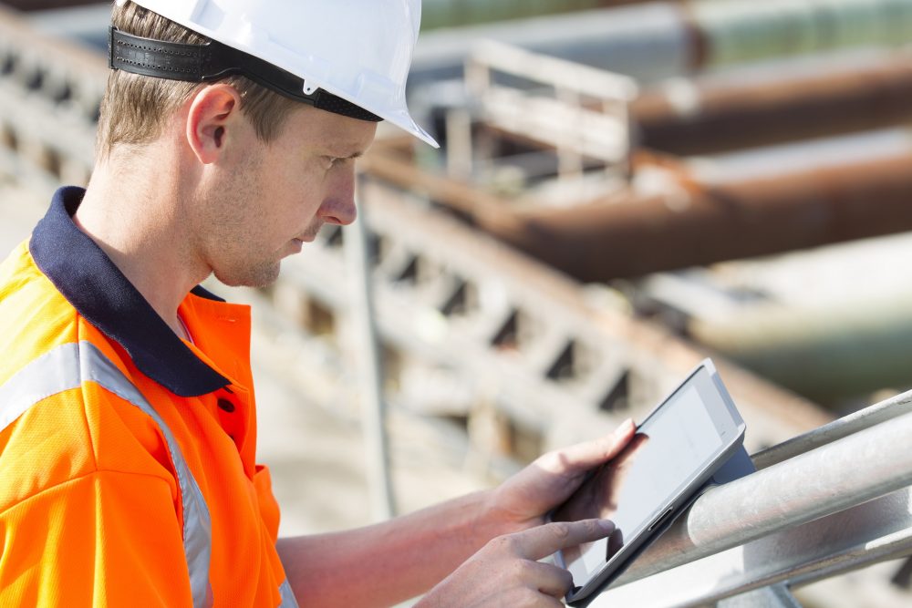 Construction worker with an Ipad at a building site