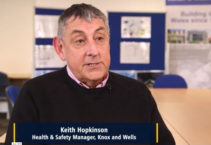 Health and Safety Manager sitting at a desk giving a video testimonial