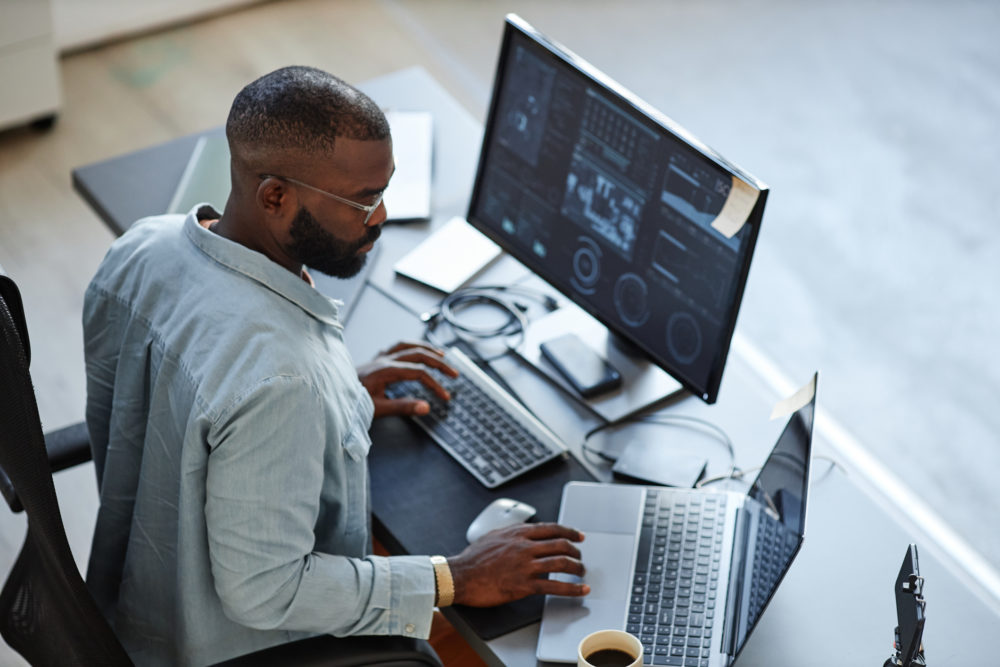 African American Software Developer logging on to create online induction