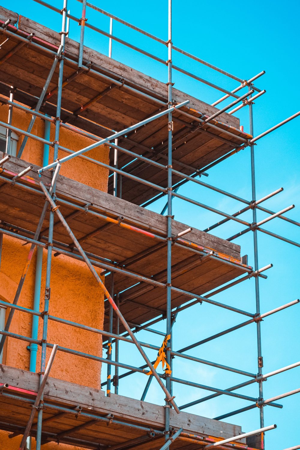 Scaffolding around a building on a site ready to be constructed