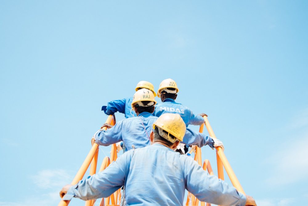 construction workers on a site walking up steps on a bright sunny day